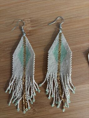 Ink + Alloy teal, gold, and cream fringe earrings.